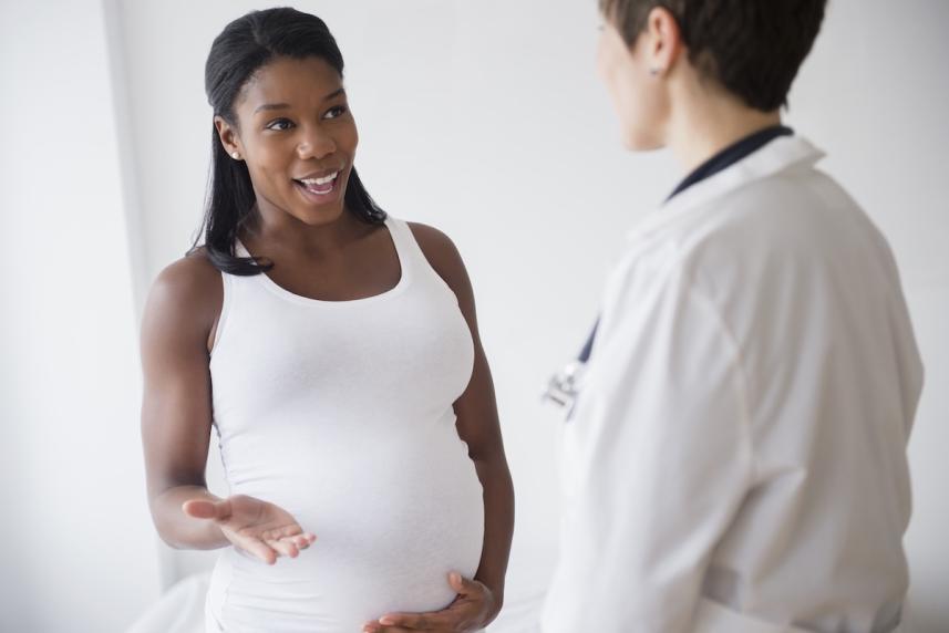 A pregnant woman talking to her doctor
