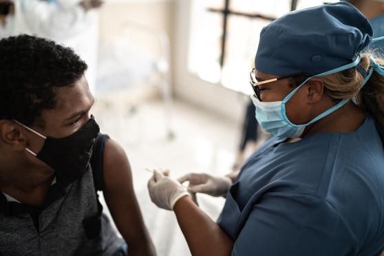Teen getting a shot at the doctor