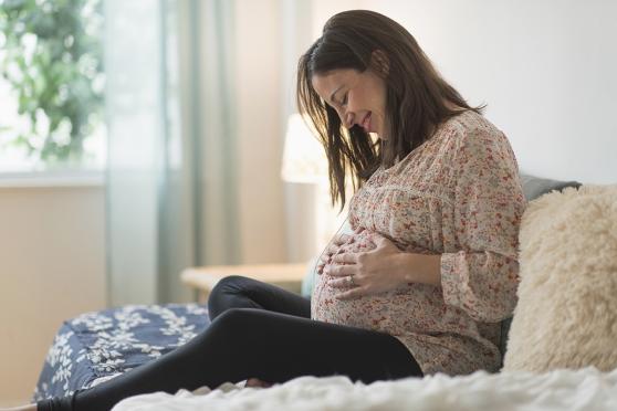 pregnant woman sitting on coach