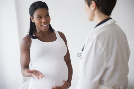 A pregnant woman talking to her doctor