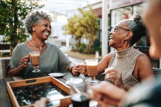Two women enjoying coffee and laughing